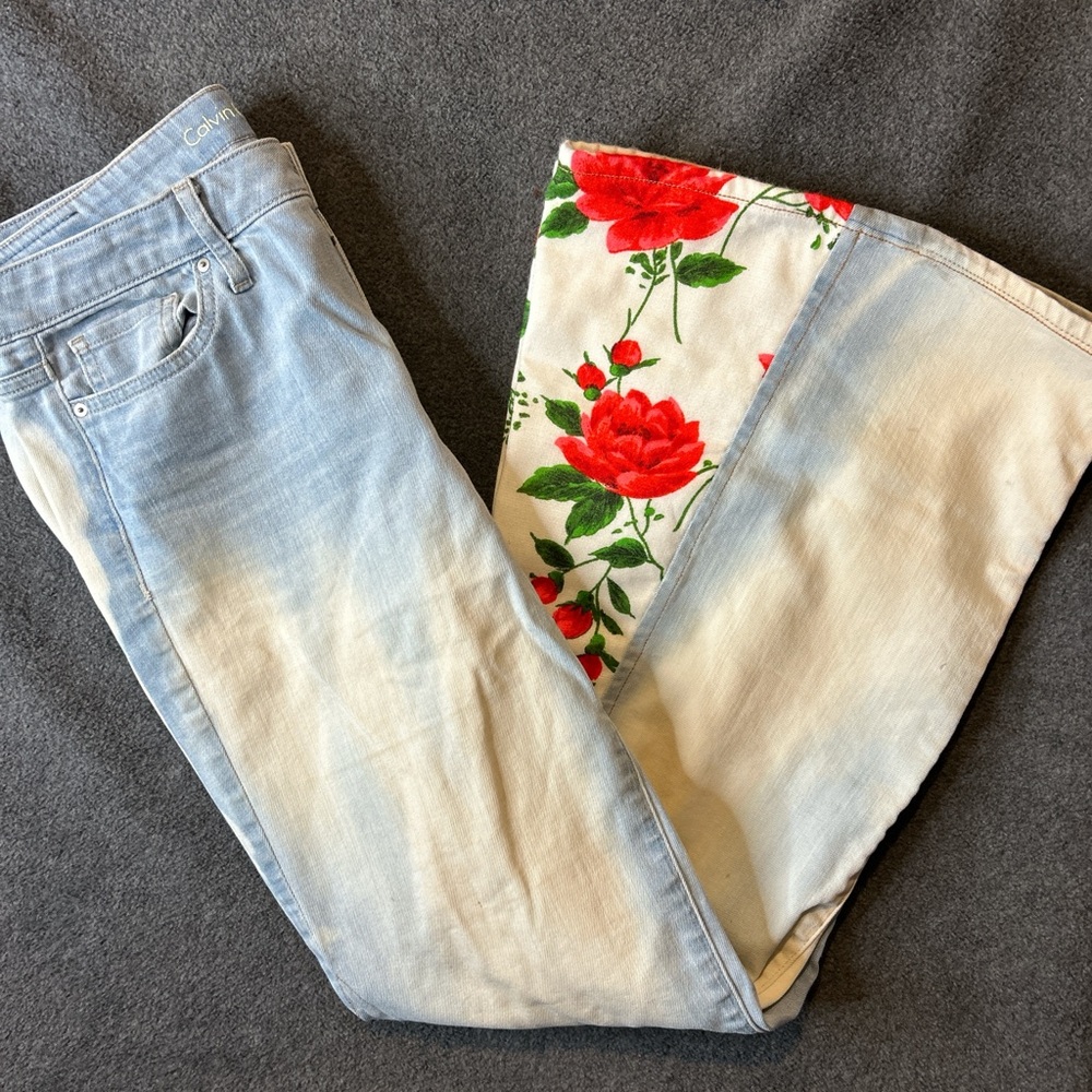 Calvin Klein reworked up-cycled blue flared stretch jeans floral inserts on legs